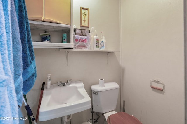 bathroom featuring toilet and sink