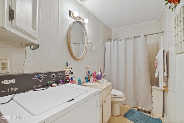 bathroom with washer / clothes dryer, vanity, a shower with curtain, toilet, and crown molding