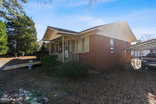 view of home's exterior featuring a carport and a porch