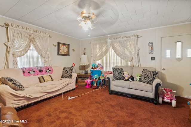 living room with ceiling fan, crown molding, and carpet flooring