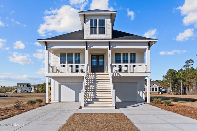 beach home with a garage, covered porch, and french doors