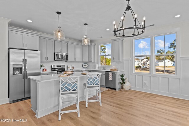 doorway featuring ornamental molding, light hardwood / wood-style flooring, and a wealth of natural light