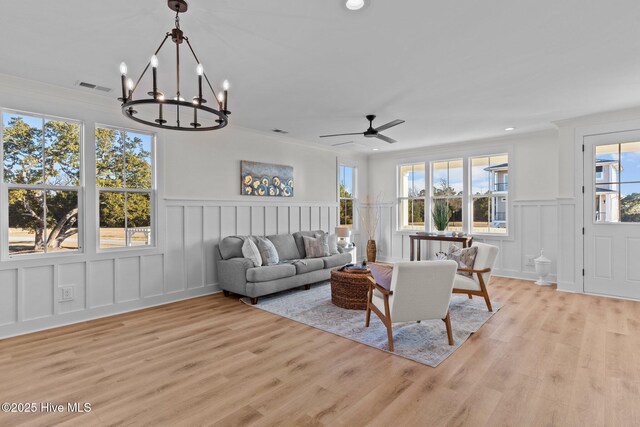 kitchen with a kitchen bar, sink, hanging light fixtures, appliances with stainless steel finishes, and a kitchen island