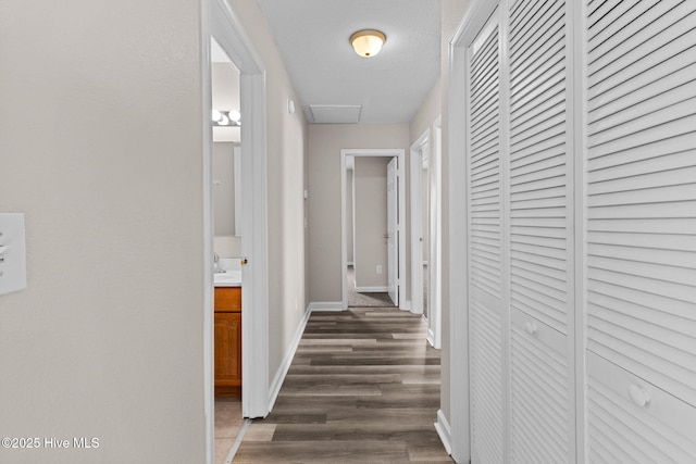 hallway featuring a textured ceiling and dark wood-type flooring