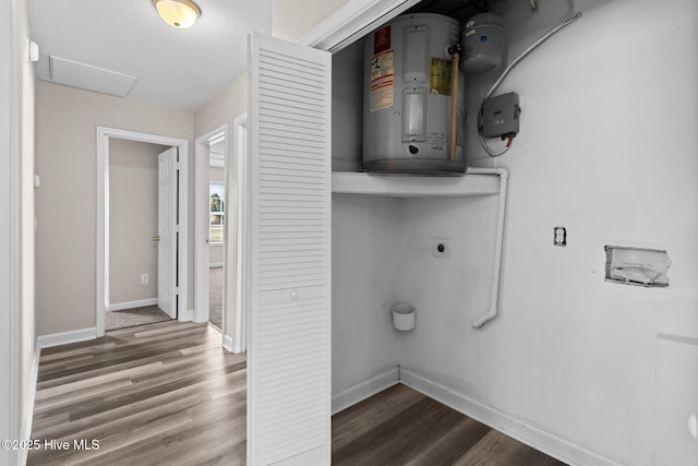 clothes washing area with water heater, a textured ceiling, wood-type flooring, and electric dryer hookup