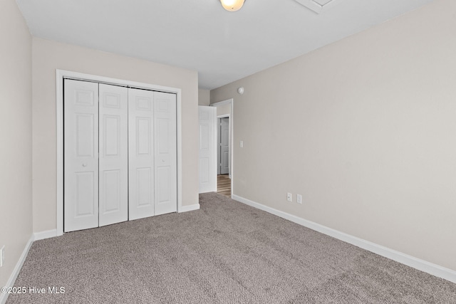 unfurnished bedroom featuring carpet and a closet