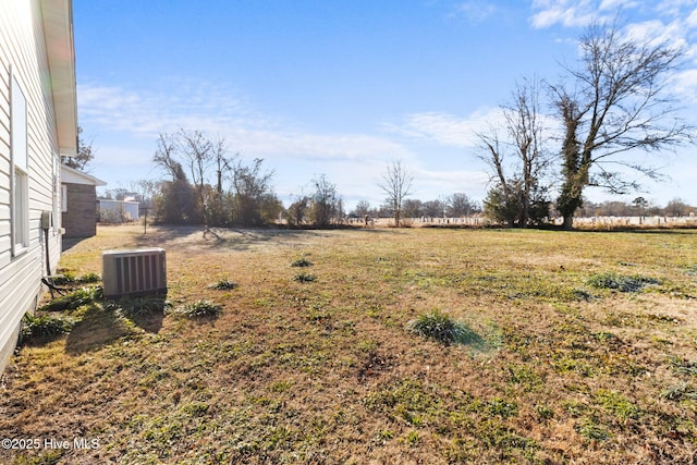 view of yard with a rural view and central air condition unit