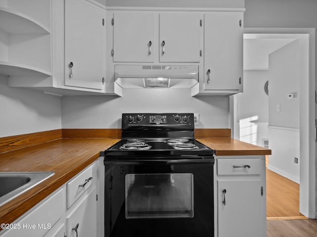 kitchen with sink, black range with electric cooktop, light hardwood / wood-style flooring, and white cabinets