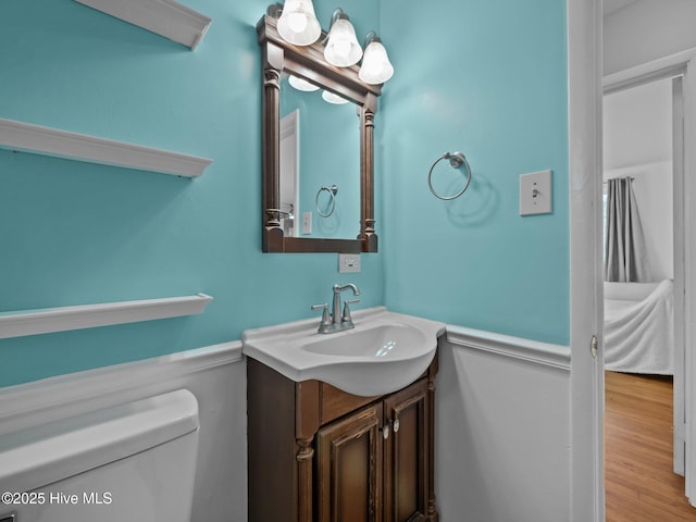 bathroom featuring vanity, toilet, and hardwood / wood-style floors