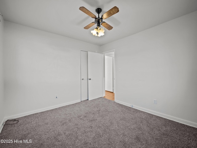 empty room featuring ceiling fan and light colored carpet