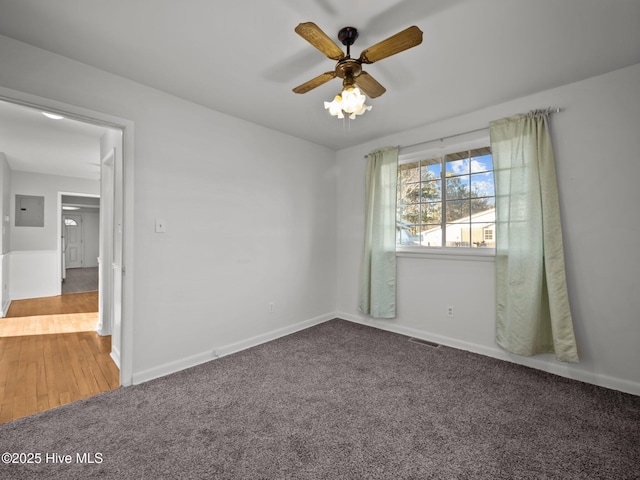 carpeted empty room featuring ceiling fan and electric panel