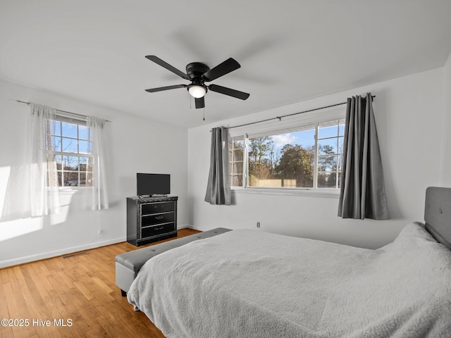 bedroom with ceiling fan and hardwood / wood-style floors