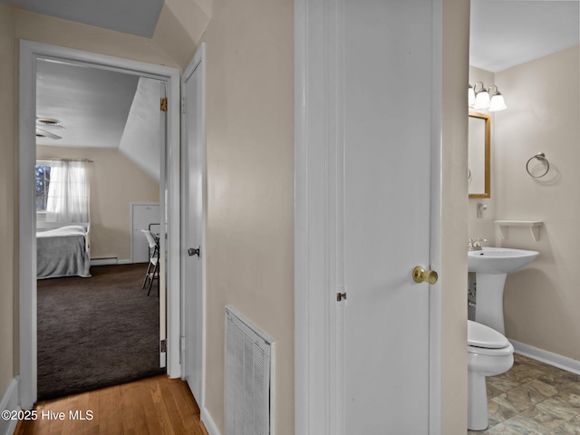 bathroom with a baseboard heating unit and toilet