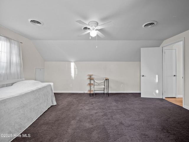 bedroom featuring dark carpet and vaulted ceiling