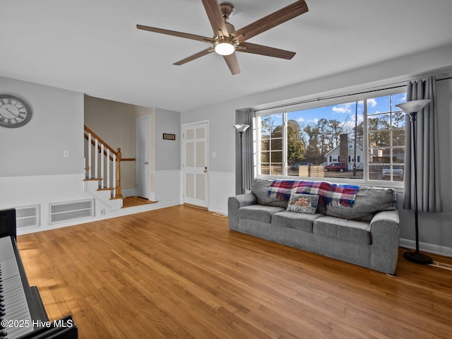 living room with ceiling fan and hardwood / wood-style floors