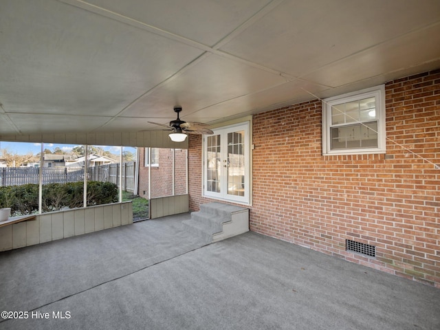 unfurnished sunroom featuring ceiling fan