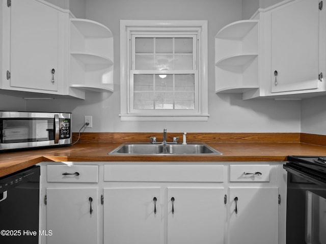 kitchen with white cabinetry, sink, and black appliances