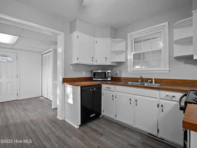 kitchen with sink, wooden counters, dark hardwood / wood-style floors, dishwasher, and white cabinets