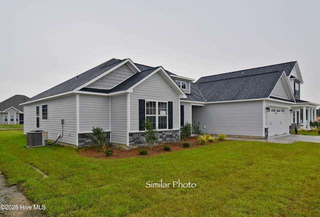 view of front facade with central AC and a front yard