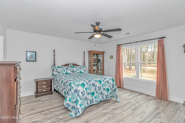 bedroom with ceiling fan and light hardwood / wood-style floors