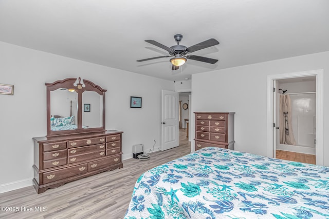 bedroom featuring connected bathroom, ceiling fan, and light wood-type flooring