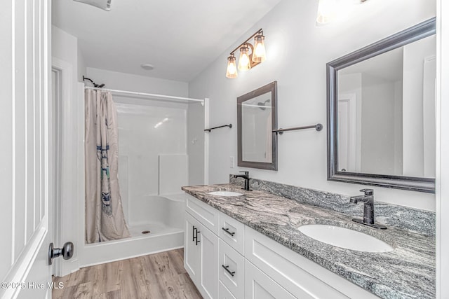 bathroom featuring vanity, hardwood / wood-style floors, and walk in shower