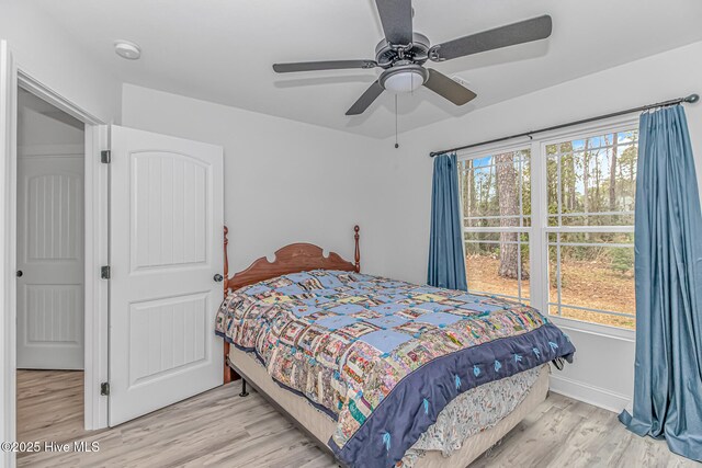 bedroom with light hardwood / wood-style flooring and ceiling fan