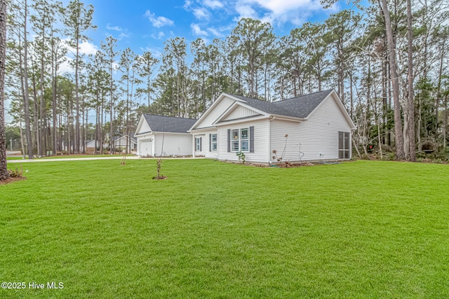 view of front of house featuring a garage and a front lawn