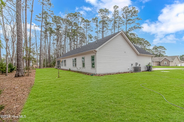 view of home's exterior with central AC unit and a lawn