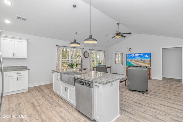 kitchen featuring dishwasher, a kitchen island with sink, sink, and white cabinets