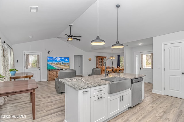 kitchen featuring sink, white cabinetry, stainless steel dishwasher, pendant lighting, and a kitchen island with sink