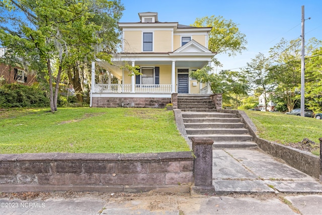traditional style home featuring covered porch and a front yard