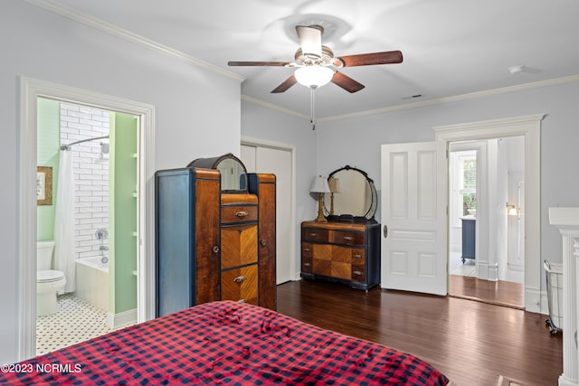 bedroom featuring ceiling fan, dark hardwood / wood-style flooring, crown molding, and ensuite bath