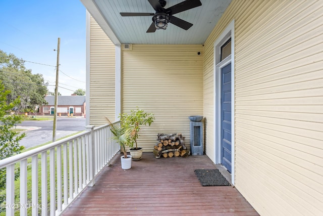 wooden terrace with ceiling fan and a porch