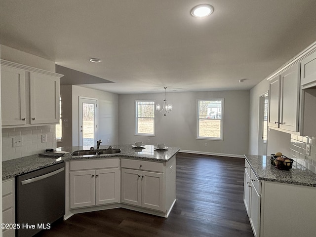 kitchen featuring white cabinetry, backsplash, stainless steel dishwasher, light stone counters, and sink