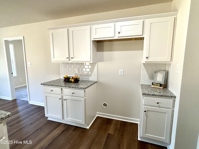 kitchen with white cabinets and tasteful backsplash