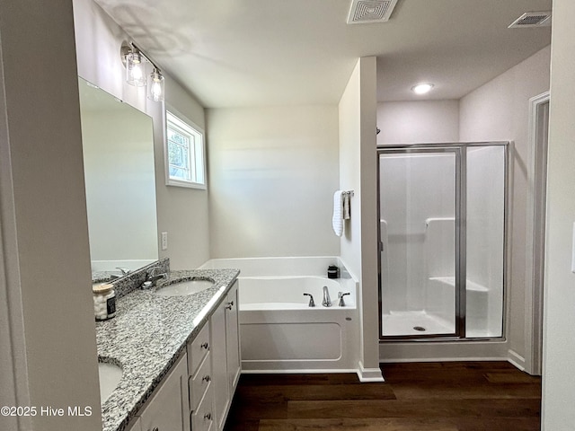 bathroom with vanity, hardwood / wood-style flooring, and shower with separate bathtub