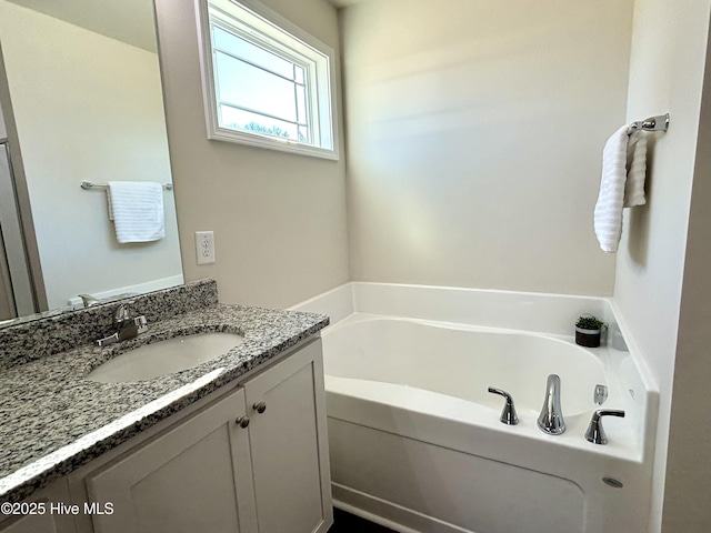 bathroom with a bath and vanity