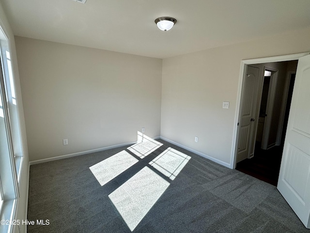 carpeted empty room with plenty of natural light