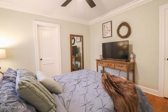 bedroom with ceiling fan, hardwood / wood-style flooring, and ornamental molding