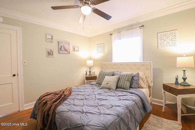 bedroom featuring ceiling fan, ornamental molding, and dark hardwood / wood-style floors