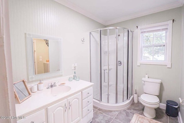 bathroom featuring walk in shower, vanity, toilet, tile patterned floors, and ornamental molding