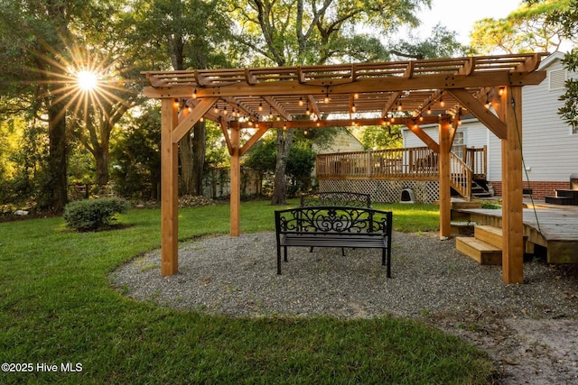 view of community with a pergola, a wooden deck, and a yard