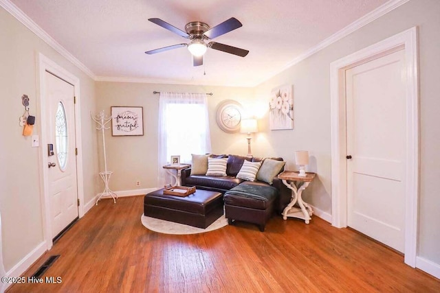 living room with ceiling fan, ornamental molding, and hardwood / wood-style flooring