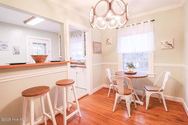 dining room featuring plenty of natural light, light hardwood / wood-style flooring, and an inviting chandelier