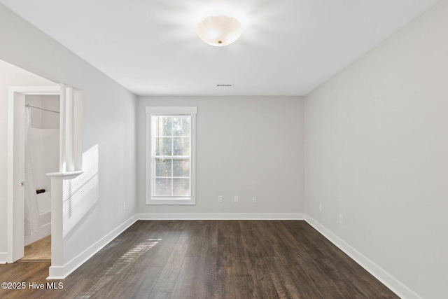 empty room featuring dark wood-type flooring