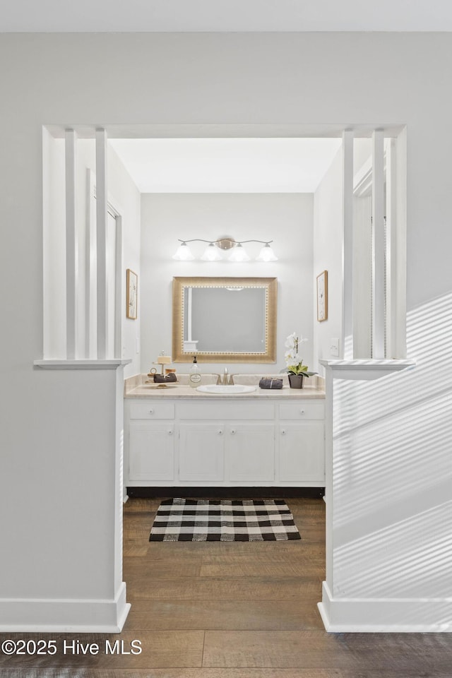 bathroom with hardwood / wood-style floors and vanity