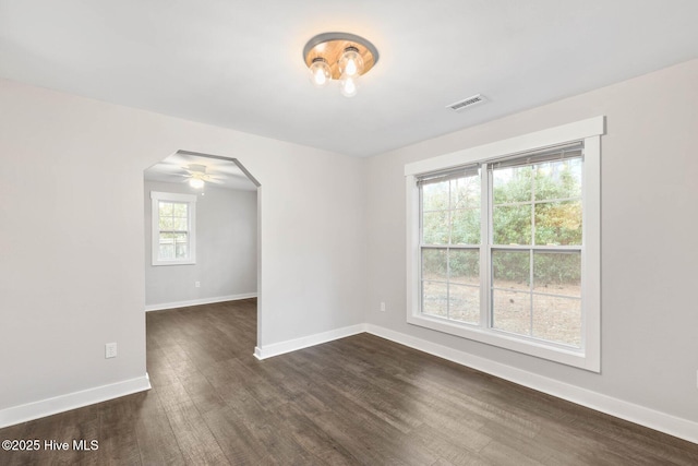 unfurnished room featuring ceiling fan and dark hardwood / wood-style flooring