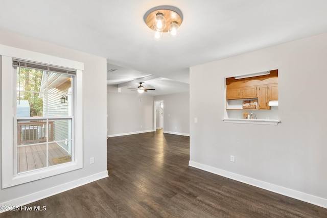 spare room featuring ceiling fan and dark hardwood / wood-style floors