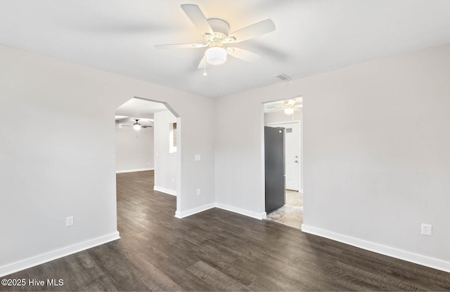 unfurnished room featuring ceiling fan and dark hardwood / wood-style flooring